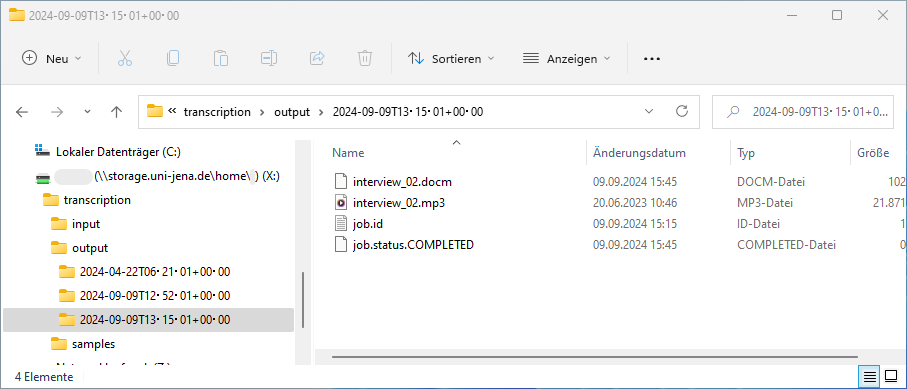 Screenshot eines Windows Explorer-Fensters, dass den Inhalt eines Transkriptions-Ausgabeverzeichnisses auf dem zentralen Netzwerkspeicher der Universitüt zeigt. Es enthält die Dateien: interview_02.docm, interview_02.mp3, job.id, and job.status.COMPLETED.